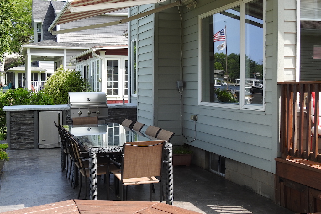 Outdoor Patio With Kitchen, Tables, and Retractable Awning